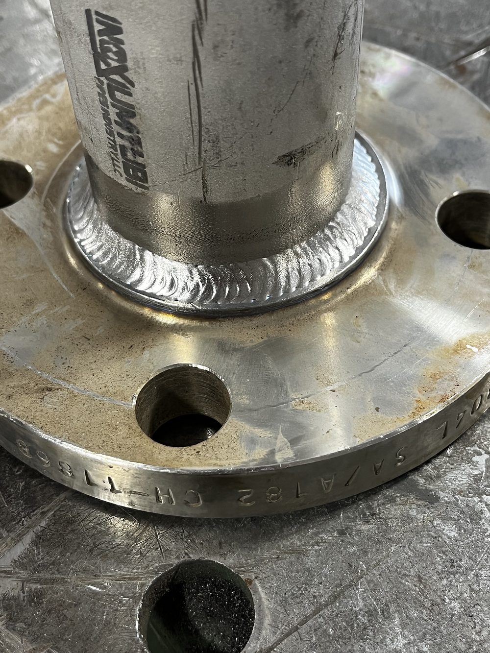 Stainless pipe welded into a raised-face flange