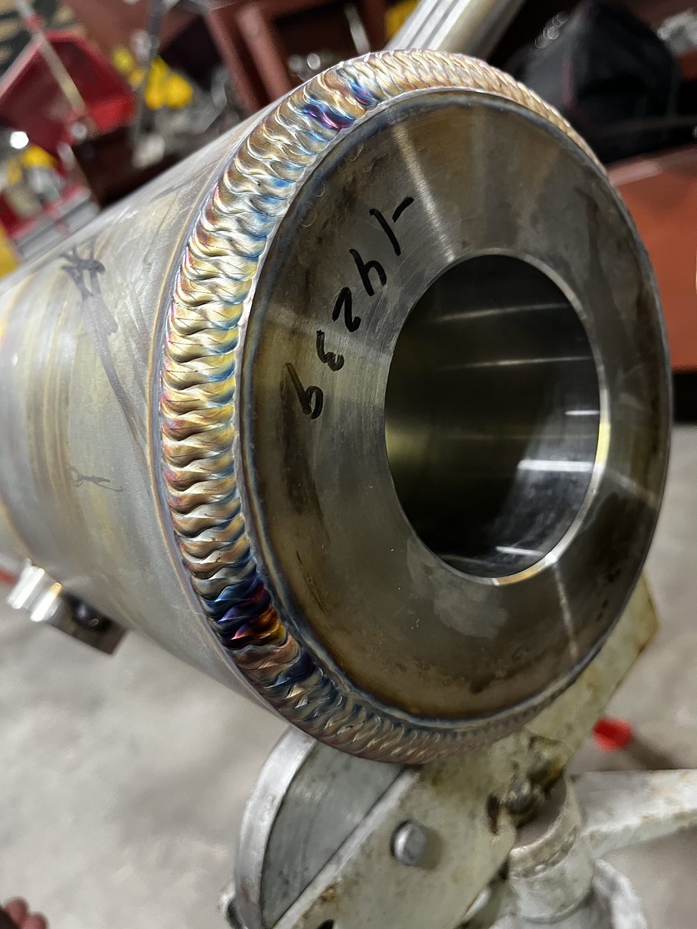 Heat-tinted weld around a machined stainless bore