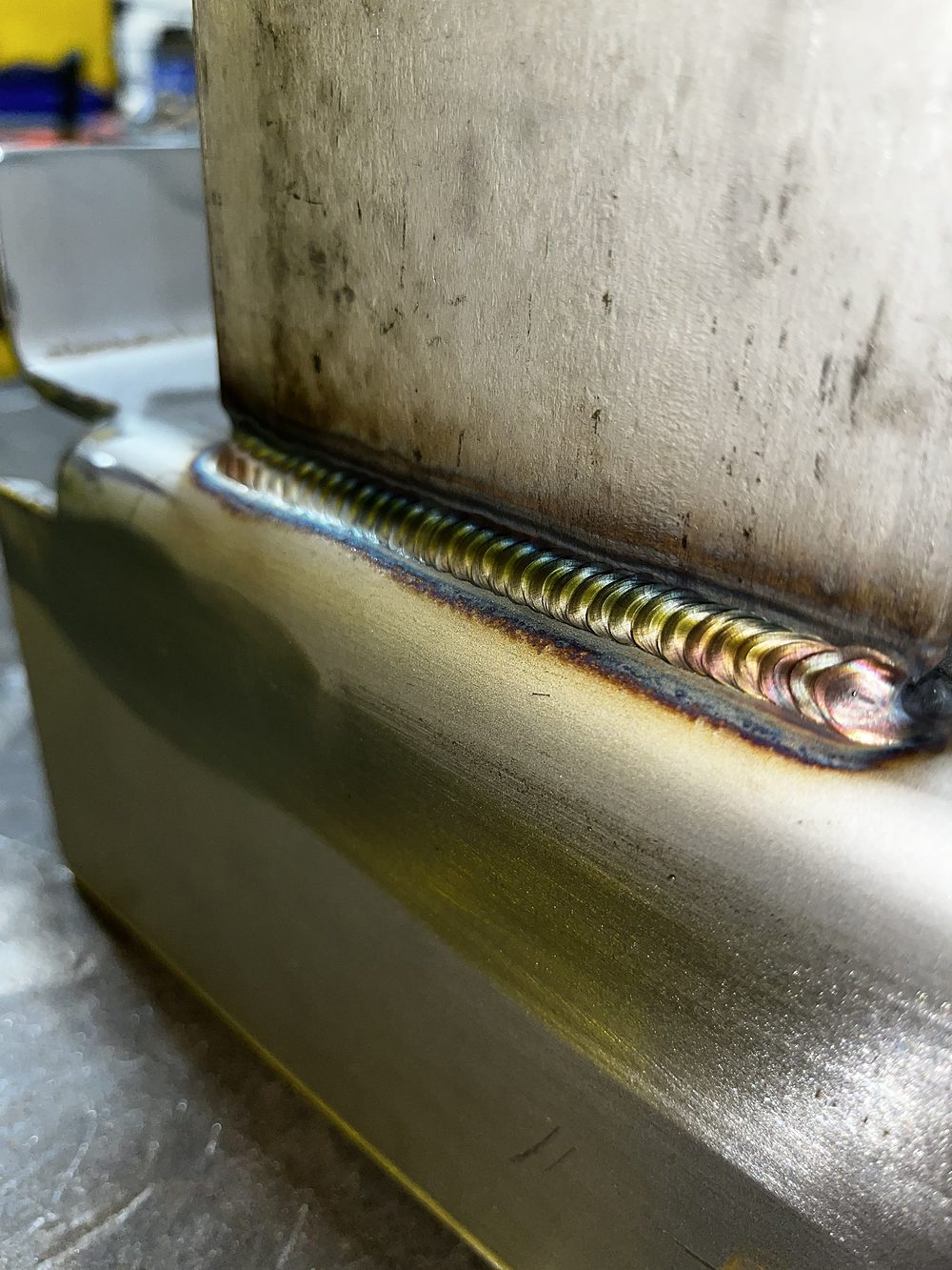 Fillet weld joining stainless plate to tube